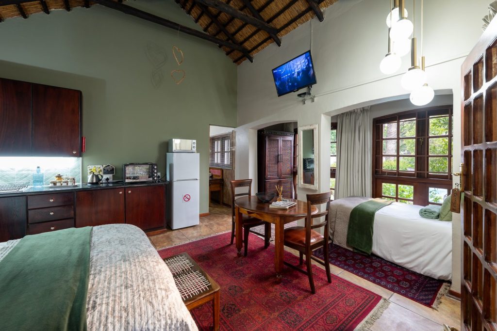 Cottage kitchenette and additional single bed at 91Waverley Guesthouse, Bloemfontein