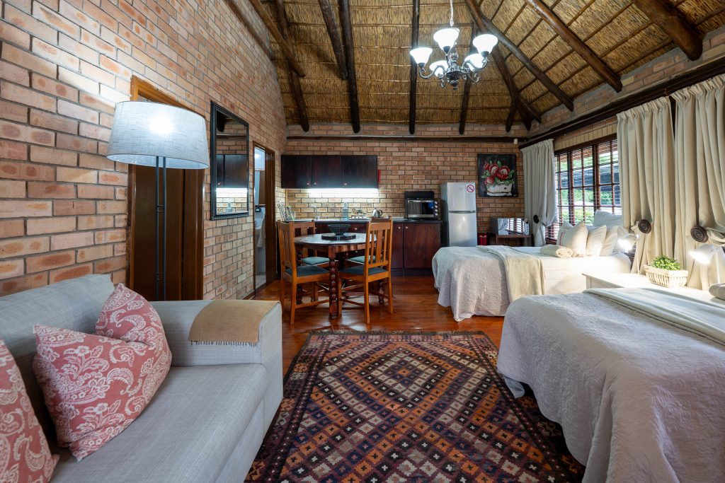Cottage 2 interior with twin beds and kitchen