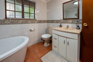 Cottage full bathroom with bath and basin at 91Waverley Guesthouse, Bloemfontein