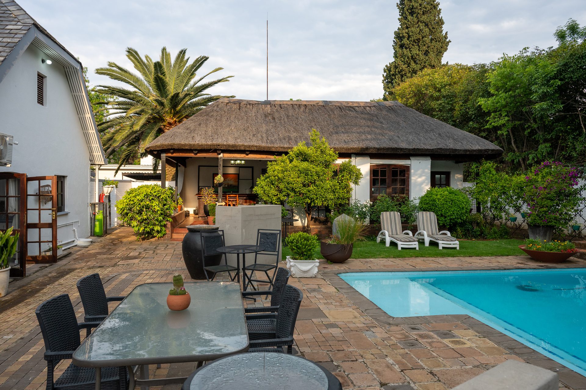 Pool courtyard and white guesthouse at 91Waverley Guesthouse, Bloemfontein